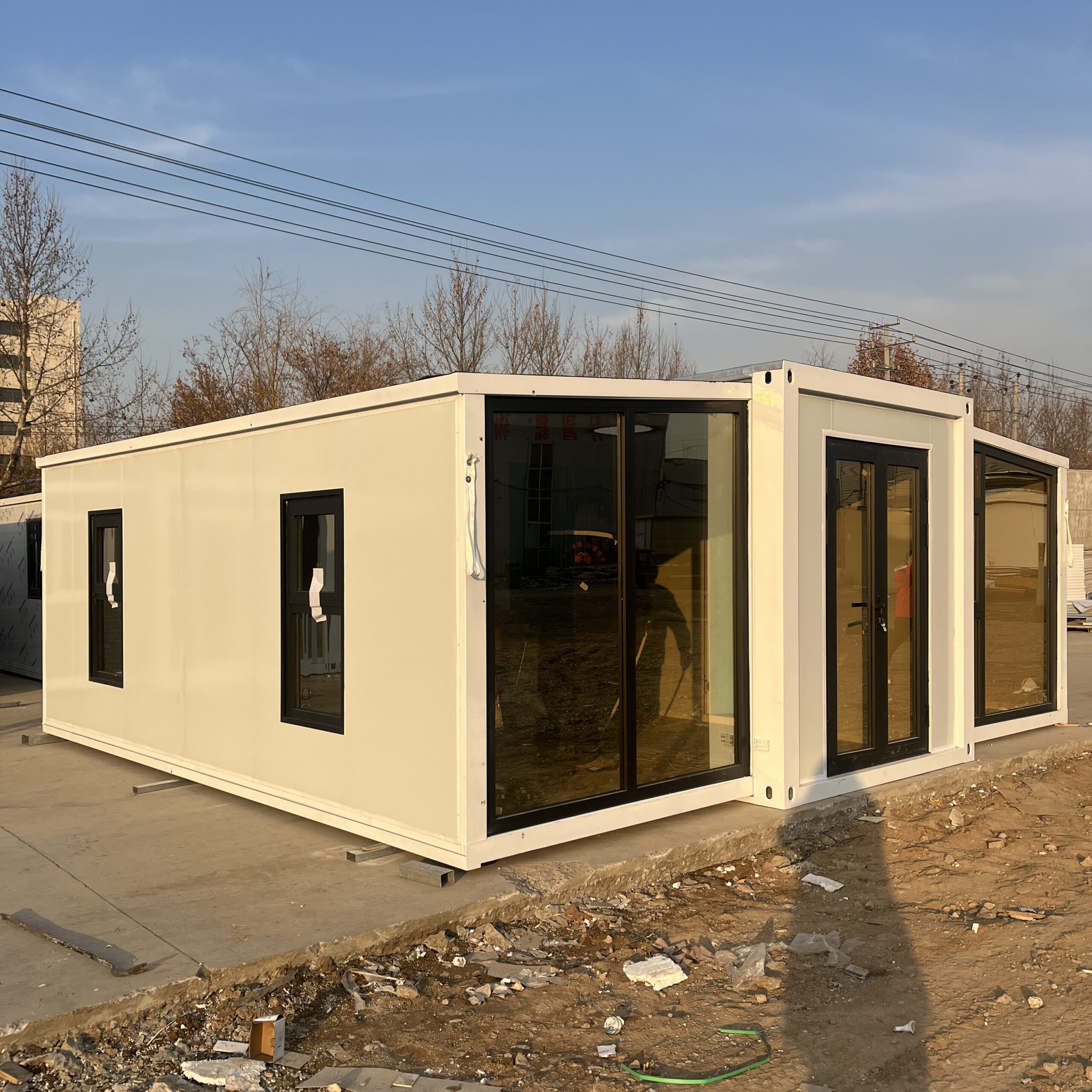 Modern glass facade container house at dusk